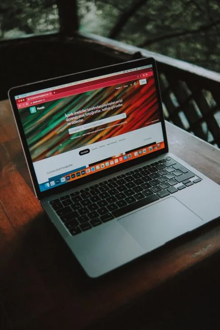 Portable computer displaying a website with a mix of abstract photos in favorites and a browser search bar with a magnifying glass icon